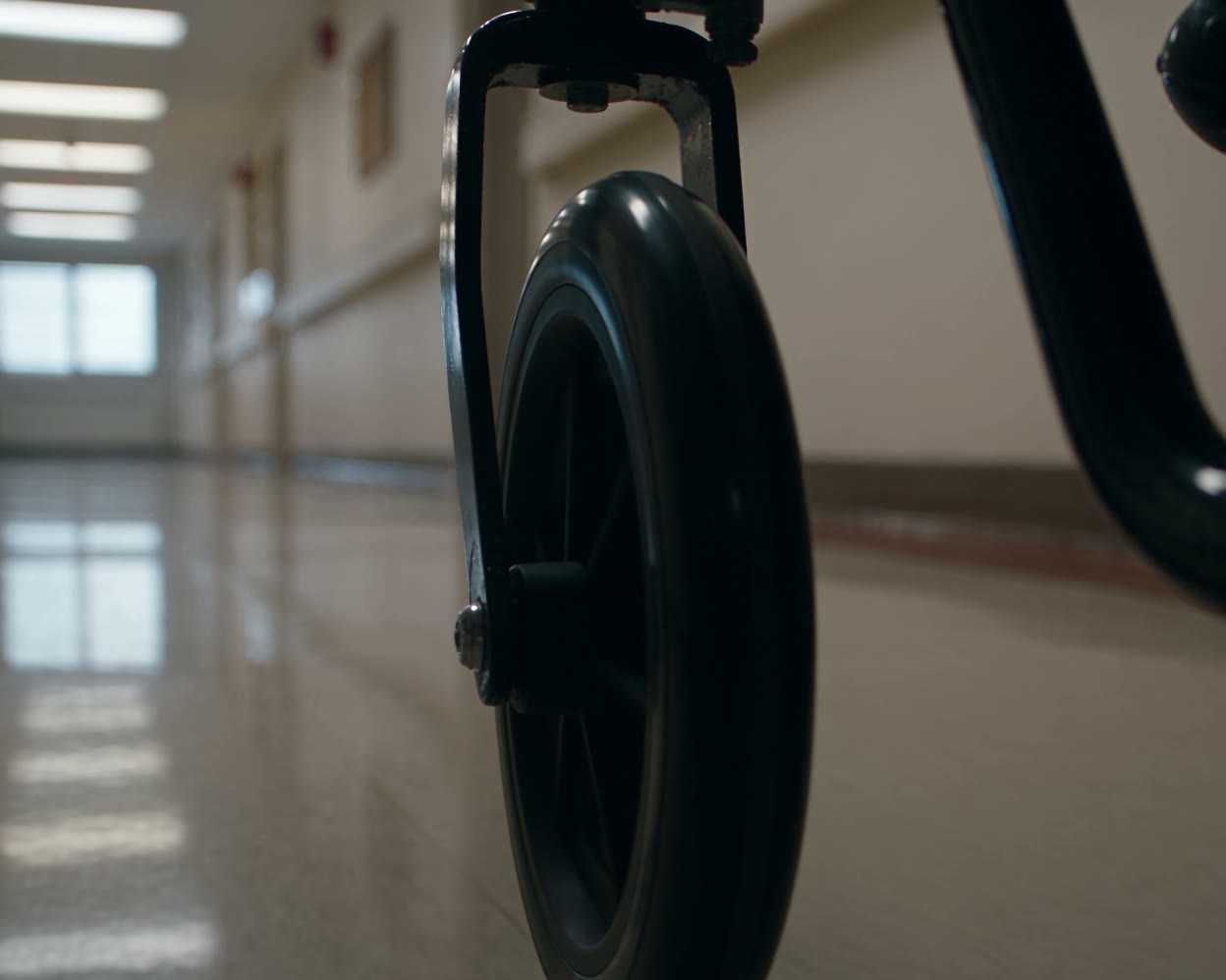 A wheelchair in a bright hospital corridor