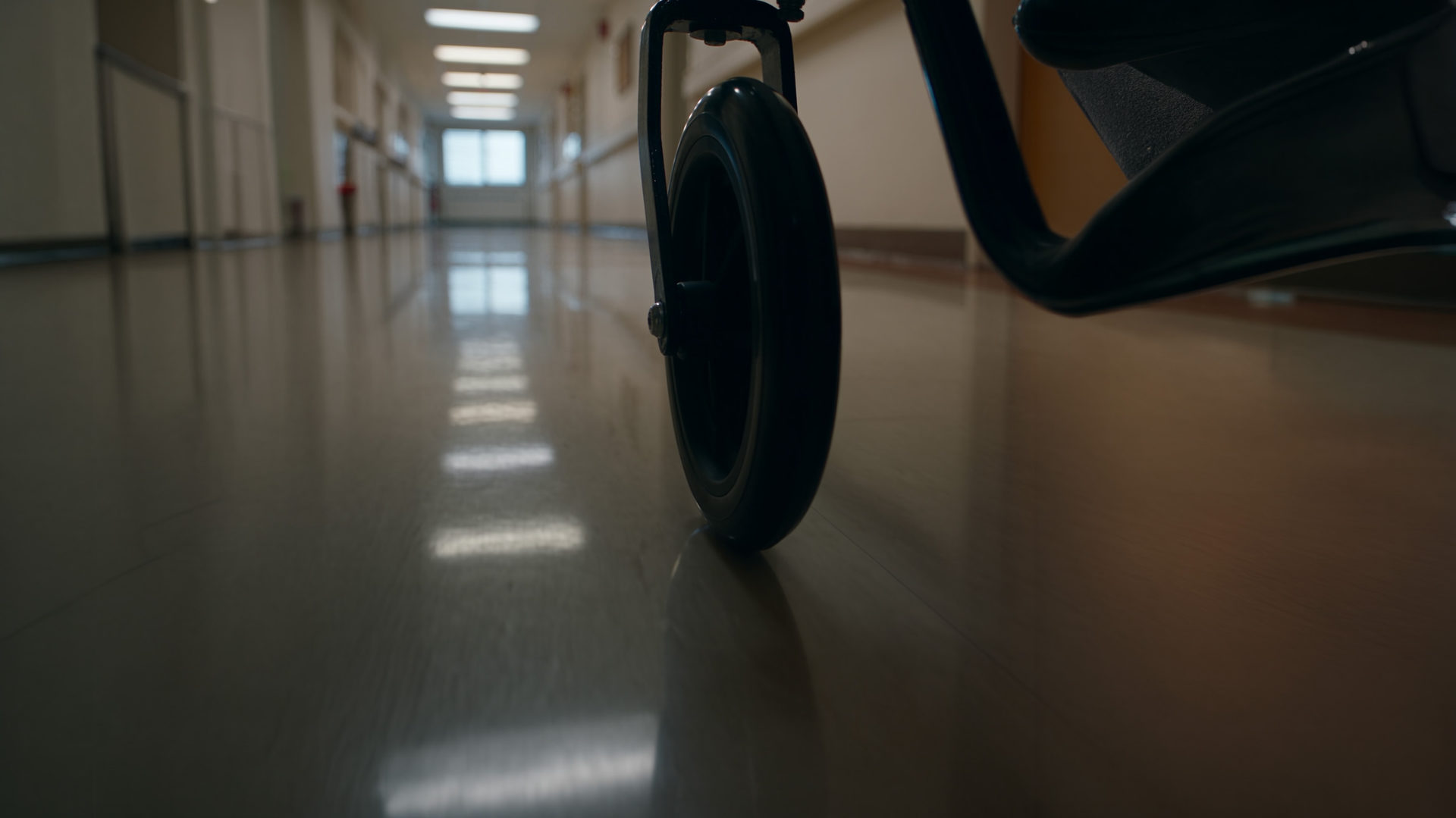 A wheelchair in a bright hospital corridor